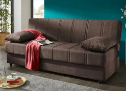 Frei im Raum aufstellbares Schlafsofa mit Dekokissen und Bettkasten